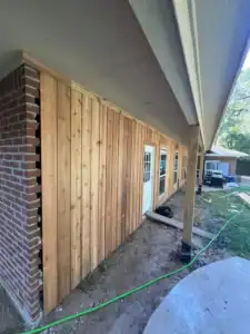 Custom ADU exterior with upgraded vertical cedar siding entry door and windows.