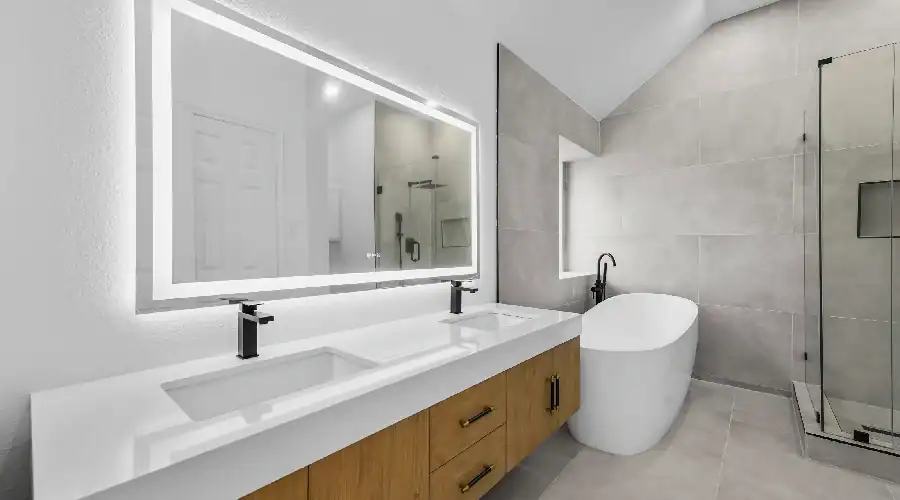 Luxury bathroom renovation in Carrollton, TX with custom vanity, soaking tub, and glass walk-in shower by Home Build and Designs.