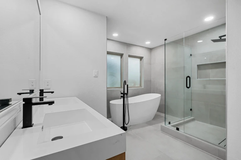 Bedford TX bathroom remodel with glass shower and freestanding tub