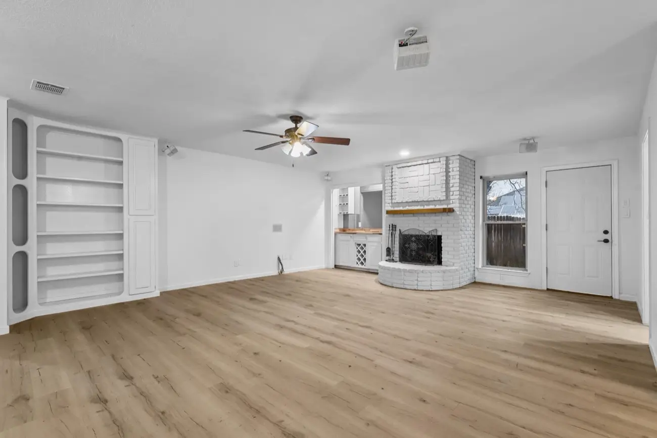 Living area after a full renovation — new flooring, paint & lighting · Bedford