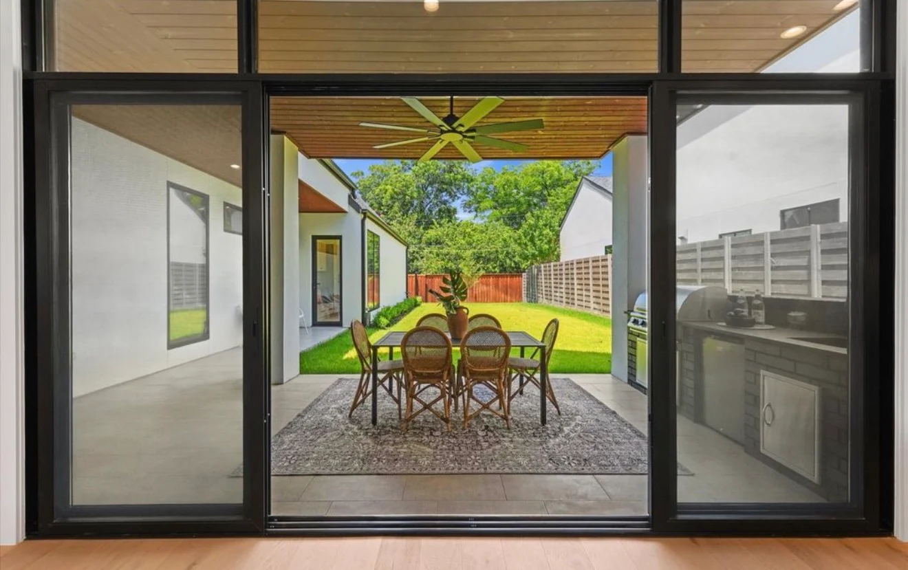 Covered outdoor living with a cedar ceiling & recessed lighting
