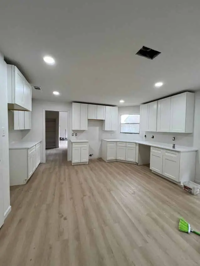 Kitchen Near Completion With White Cabinets Light Wood Flooring And 025