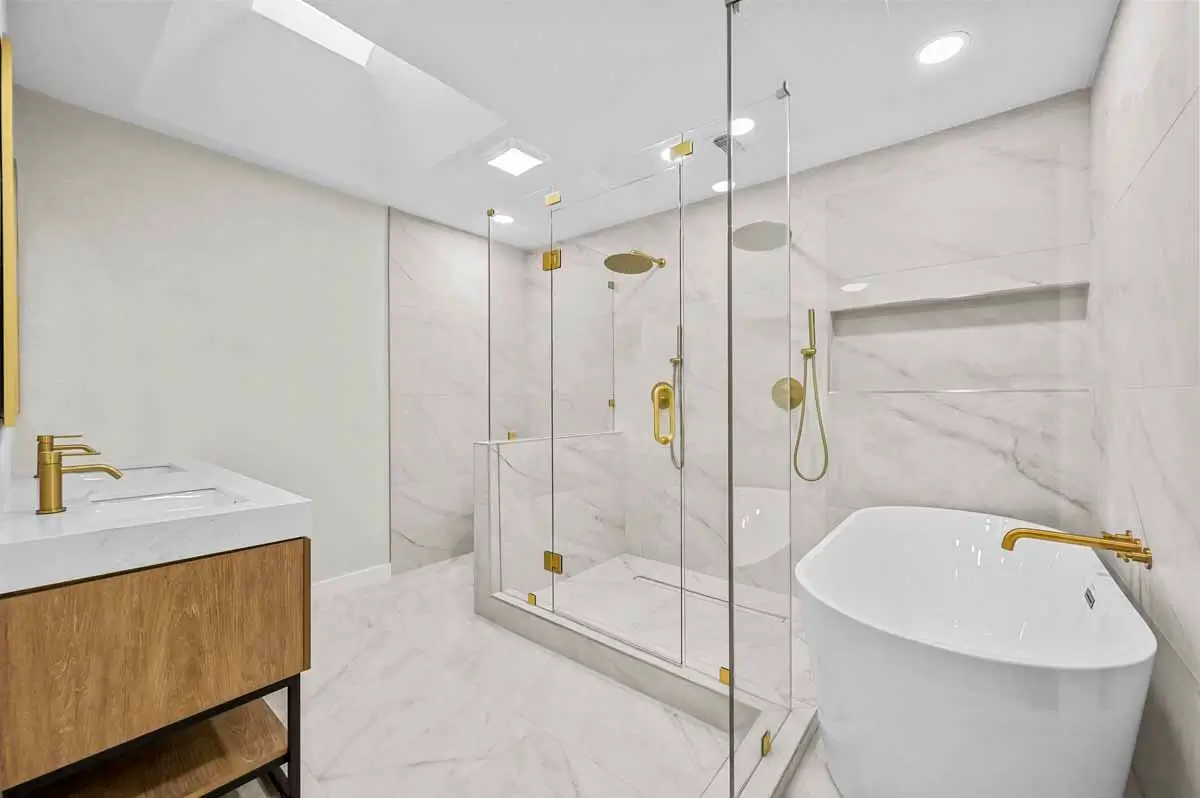 Remodeled Primary Bathroom With Glass Shower Freestanding Tub Marble Look Tile 007