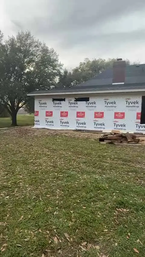 Wide Exterior View Of A Weather Wrapped Home Addition Beside 113